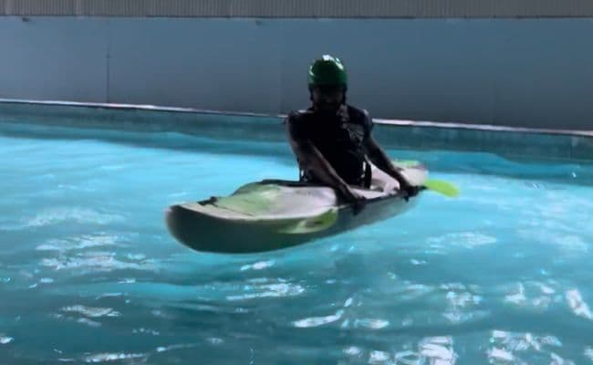 Practicing eskimo roll in the swimming pool