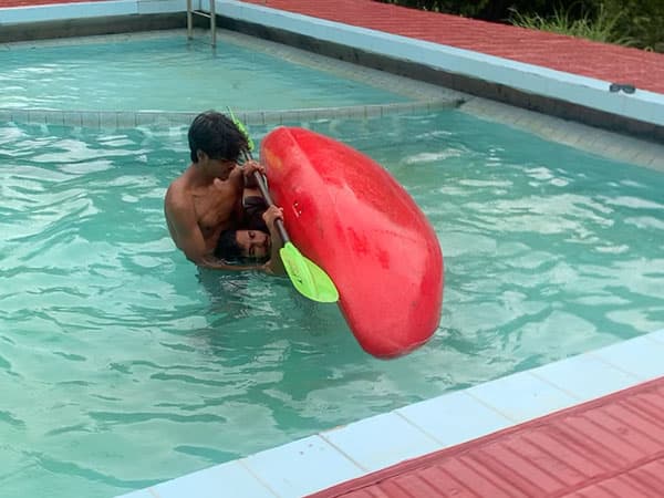 Practicing roll in swimming pool